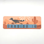Bookmark with roadrunner cactus landscape and quote "booking it" on an orange background