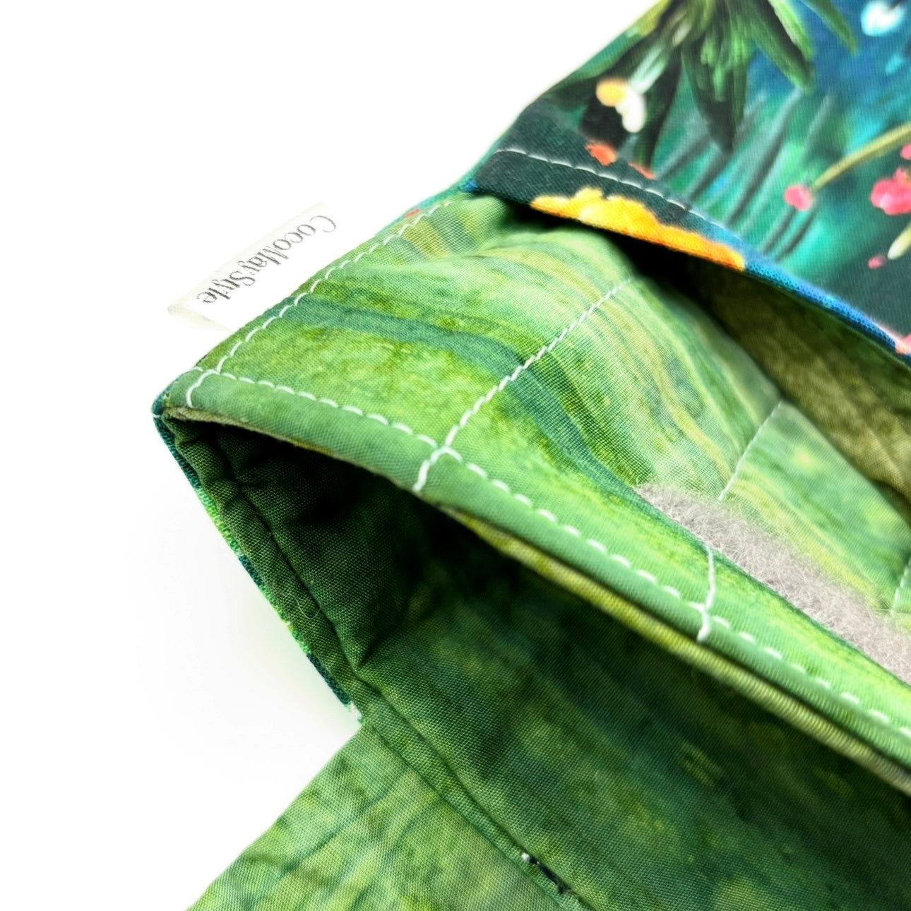 Close-up of e-Reader sleeve with colorful floral and plant pattern on a blue background