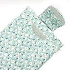 E-Reader sleeve with floral patterned fabric on a light blue background showing open velcro flap