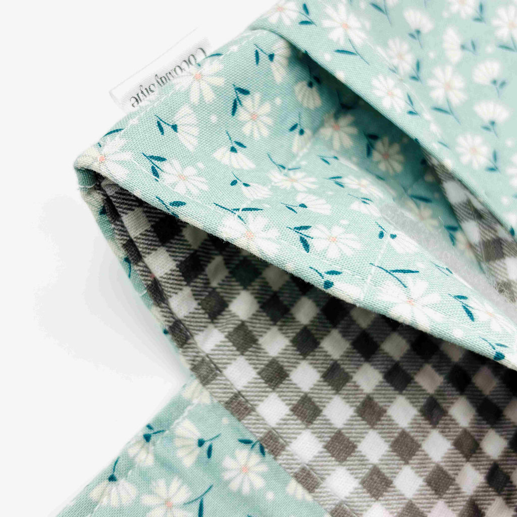 Close-up of e-Reader sleeve with floral patterned fabric on a light blue background
