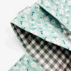 Close-up of e-Reader sleeve with floral patterned fabric on a light blue background