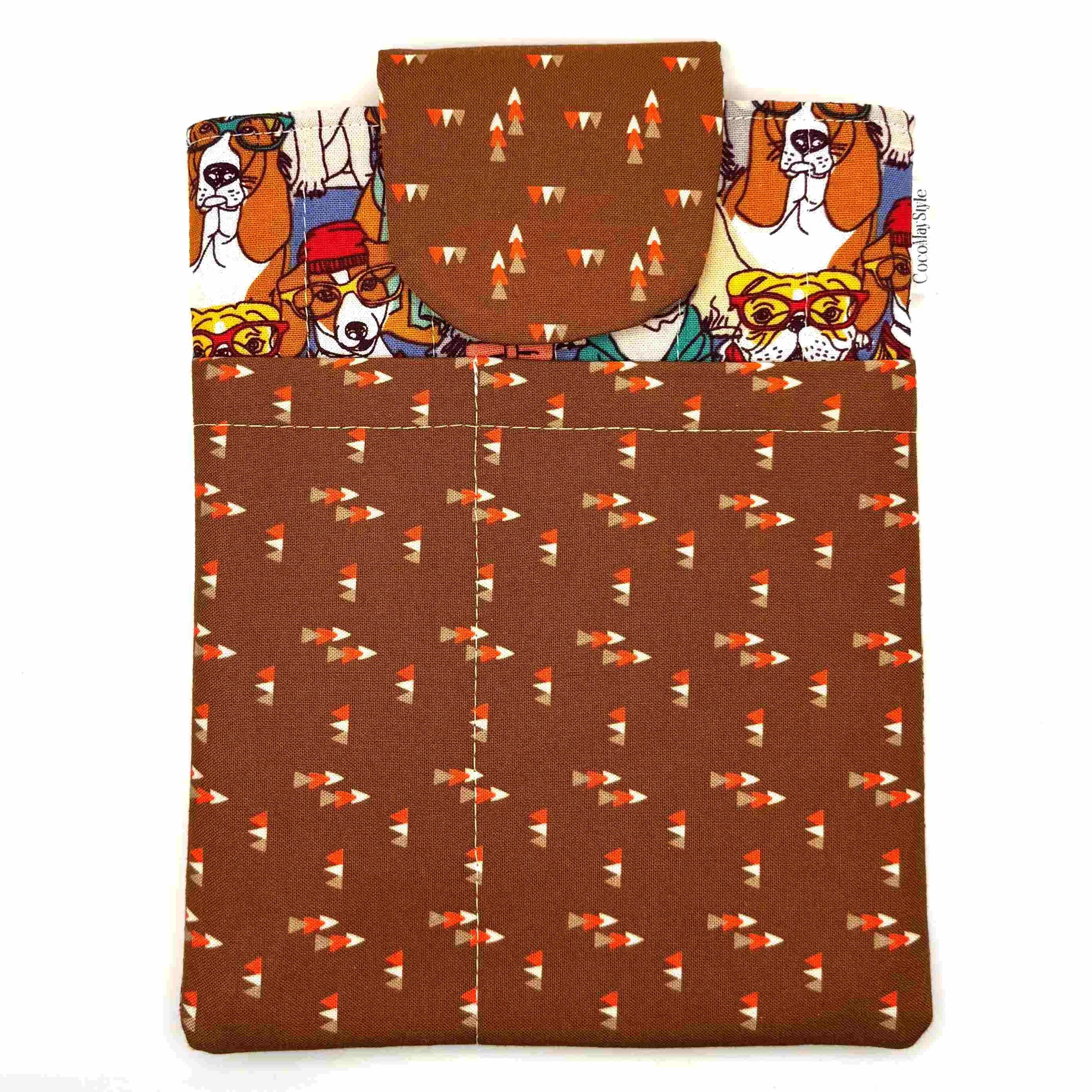 E-Reader sleeve with patterned dogs wearing hats, glasses, and scarves