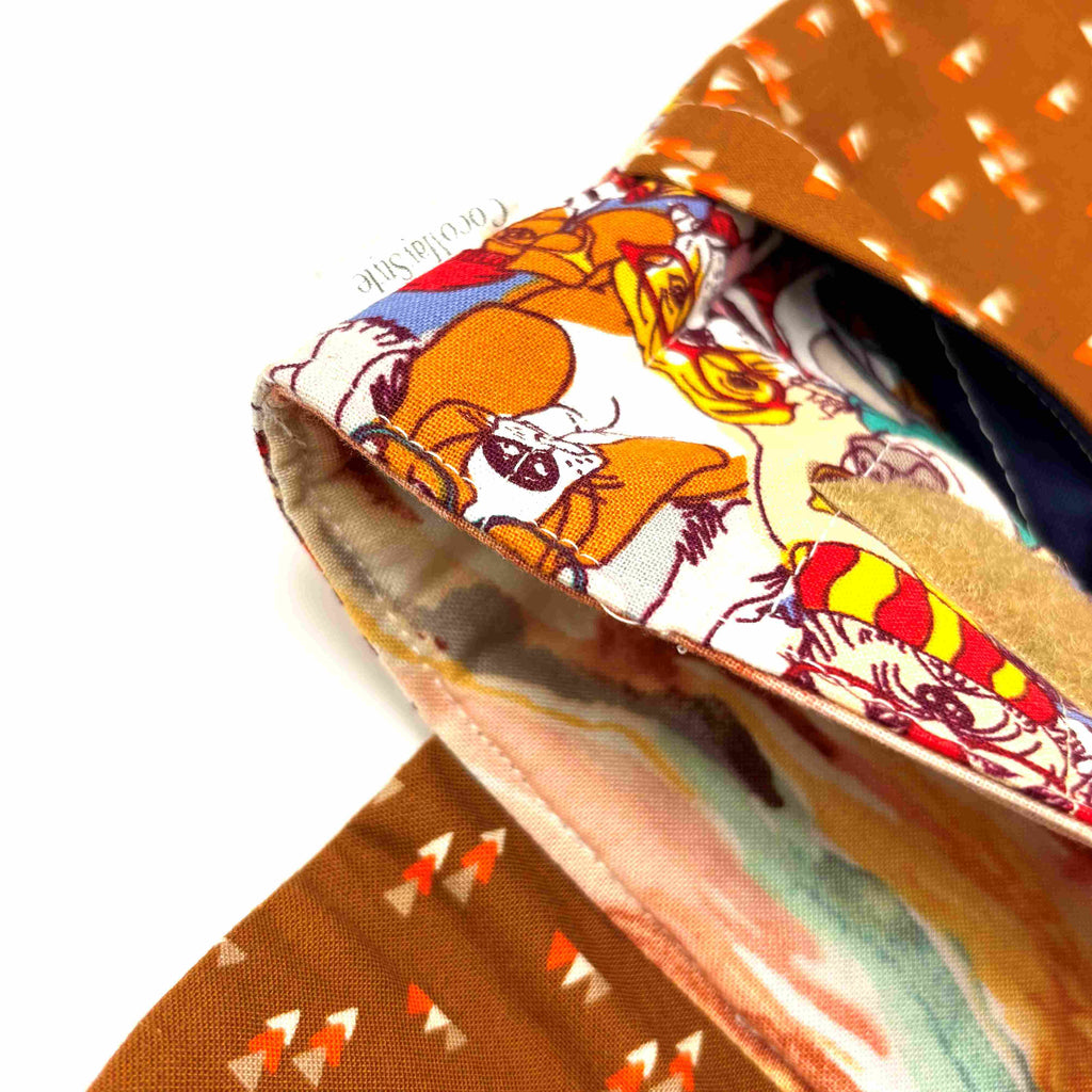 Close-up of e-Reader sleeve with patterned dogs wearing hats, glasses, and scarves