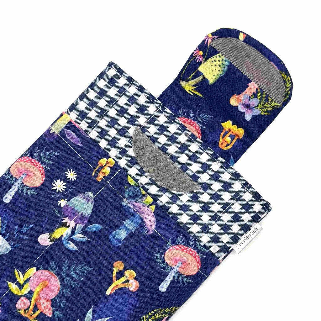 E-Reader sleeve with mushroom and foliage design on a blue background showing the open velcro flap