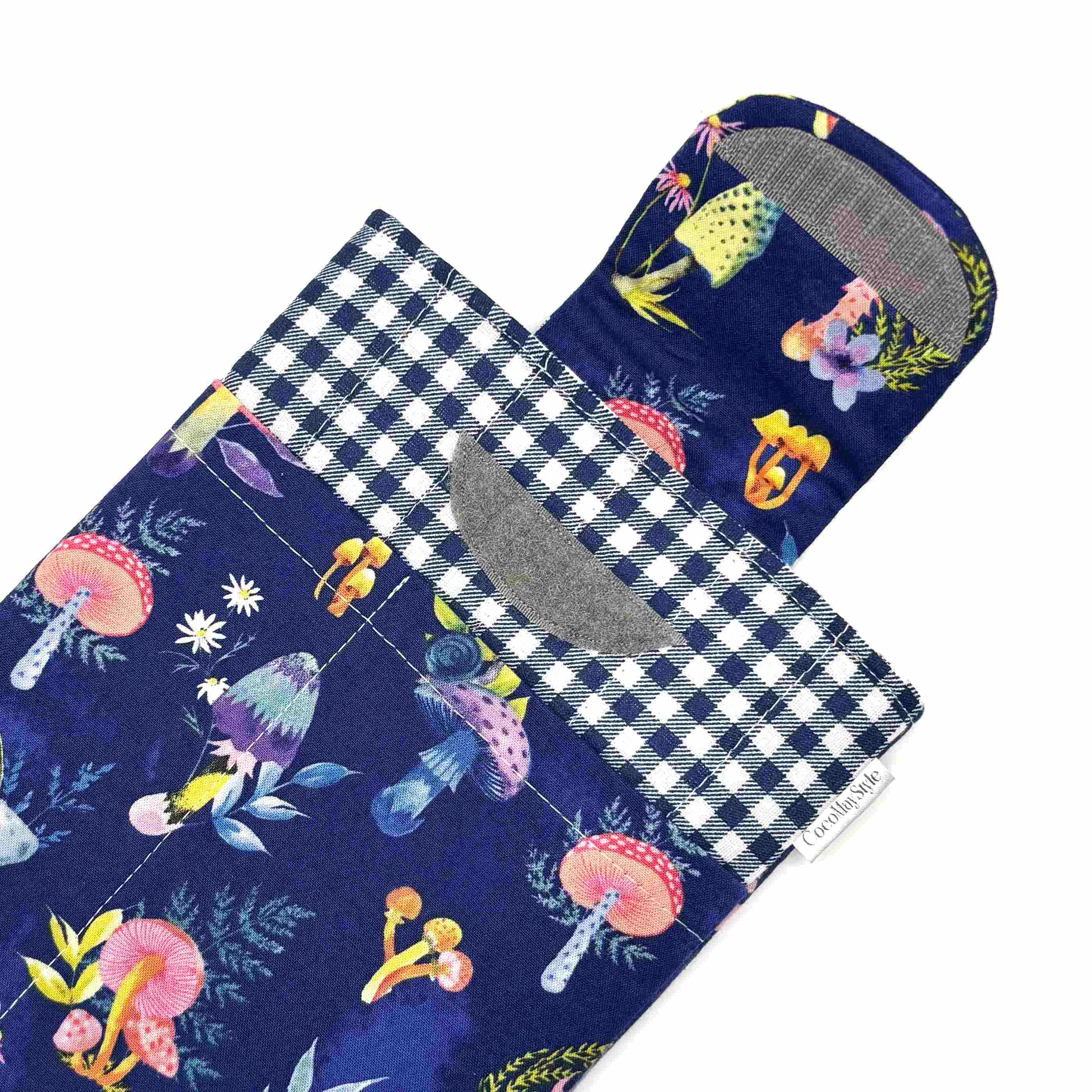 E-Reader sleeve with mushroom and foliage design on a blue background showing the open velcro flap