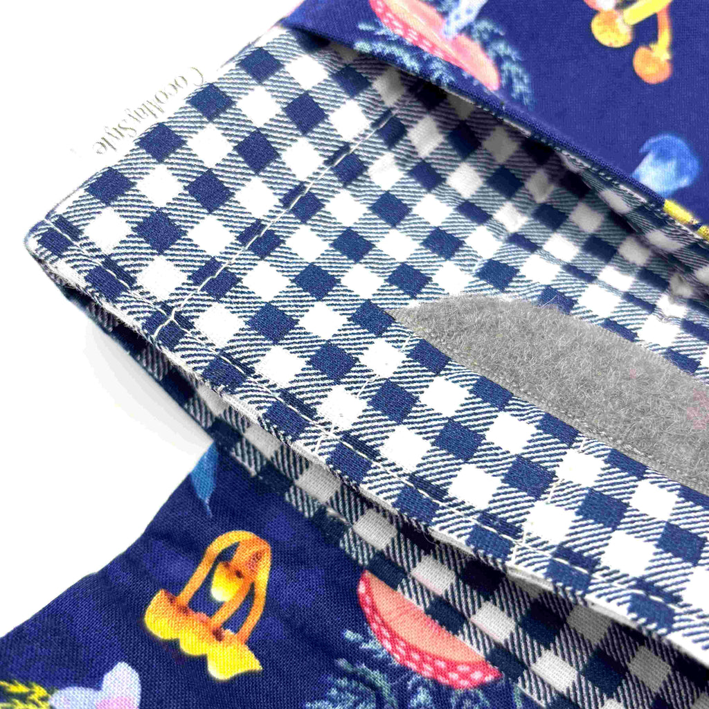 Close-up of e-Reader sleeve with mushroom and foliage design on a blue background