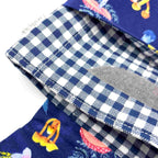 Close-up of e-Reader sleeve with mushroom and foliage design on a blue background