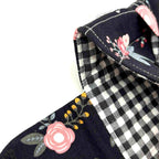 Close-up of e-Reader sleeve with pink florals on a black background