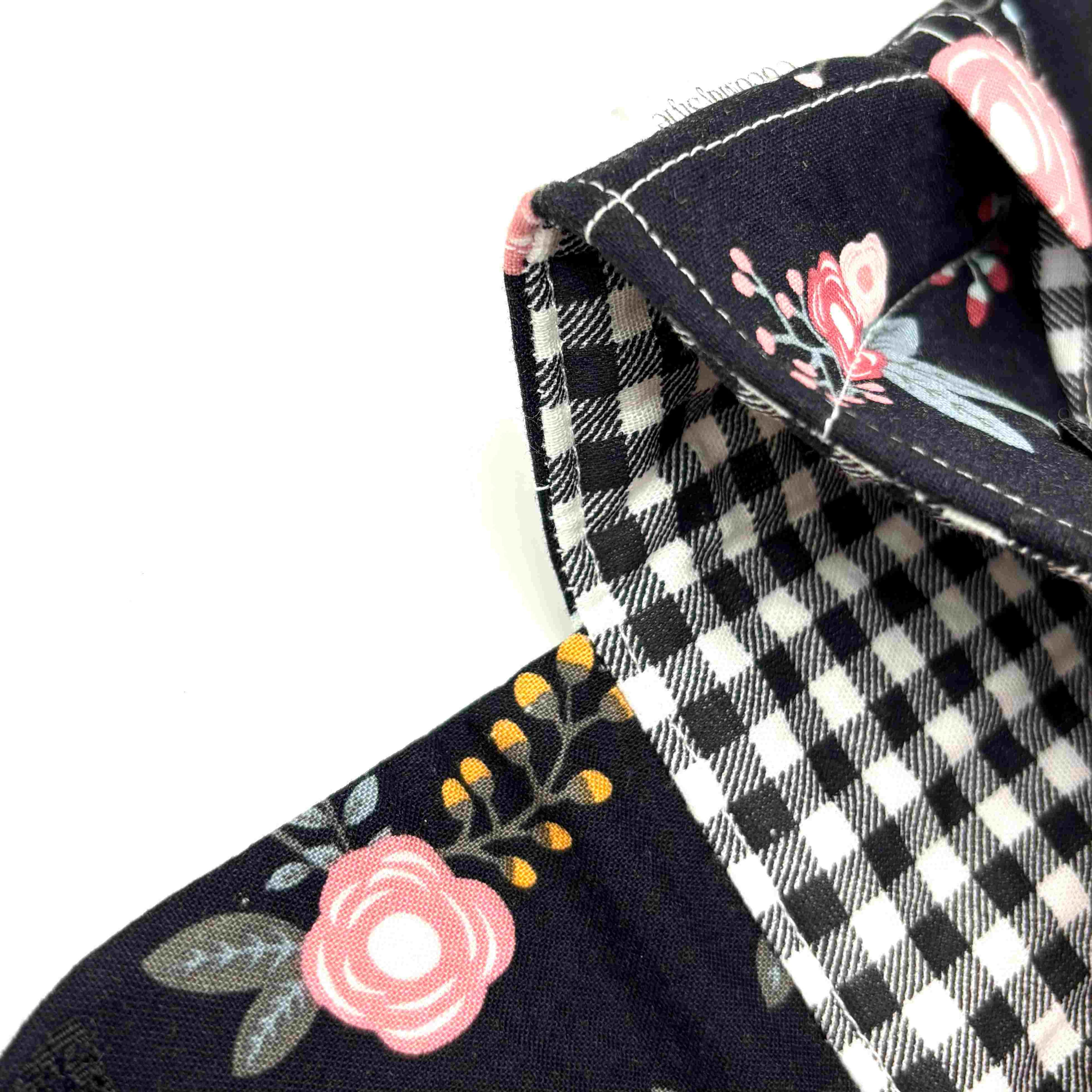 Close-up of e-Reader sleeve with pink florals on a black background