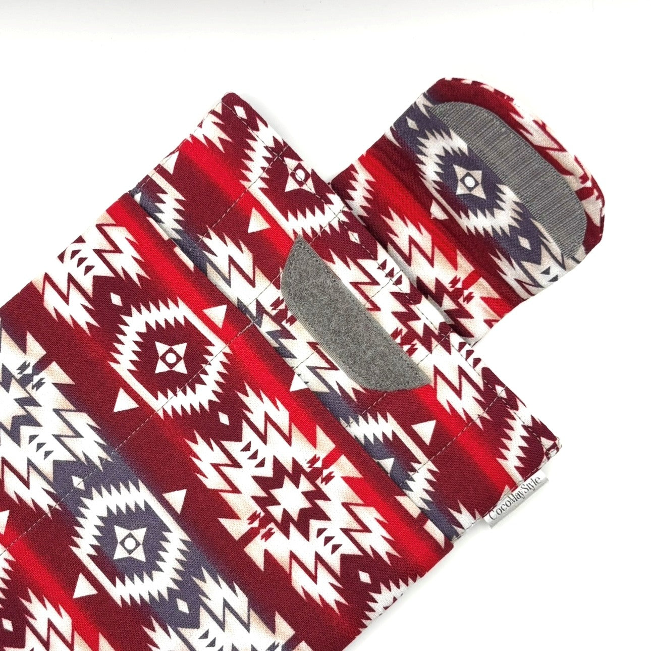 E-Reader sleeve with red and white patterned fabric with geometric design showing open velcro flap