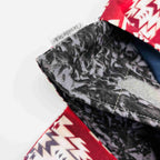 Close-up of e-Reader sleeve with red and white patterned fabric with geometric design