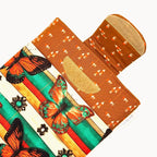 E-Reader sleeve with butterfly design on a striped background showing open velcro flap.