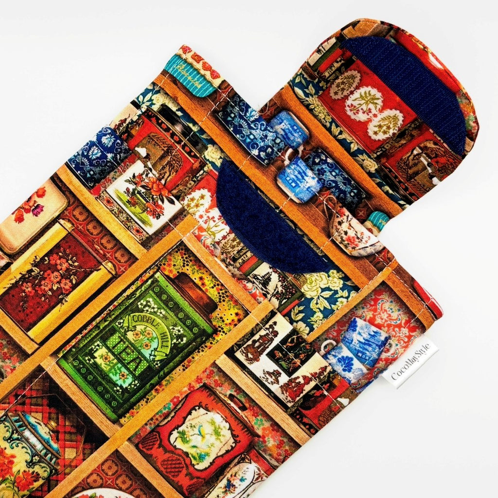 E-Reader sleeve with colorful tea tins displayed on a shelf pattern showing open velcro flap