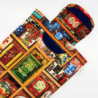 E-Reader sleeve with colorful tea tins displayed on a shelf pattern showing open velcro flap
