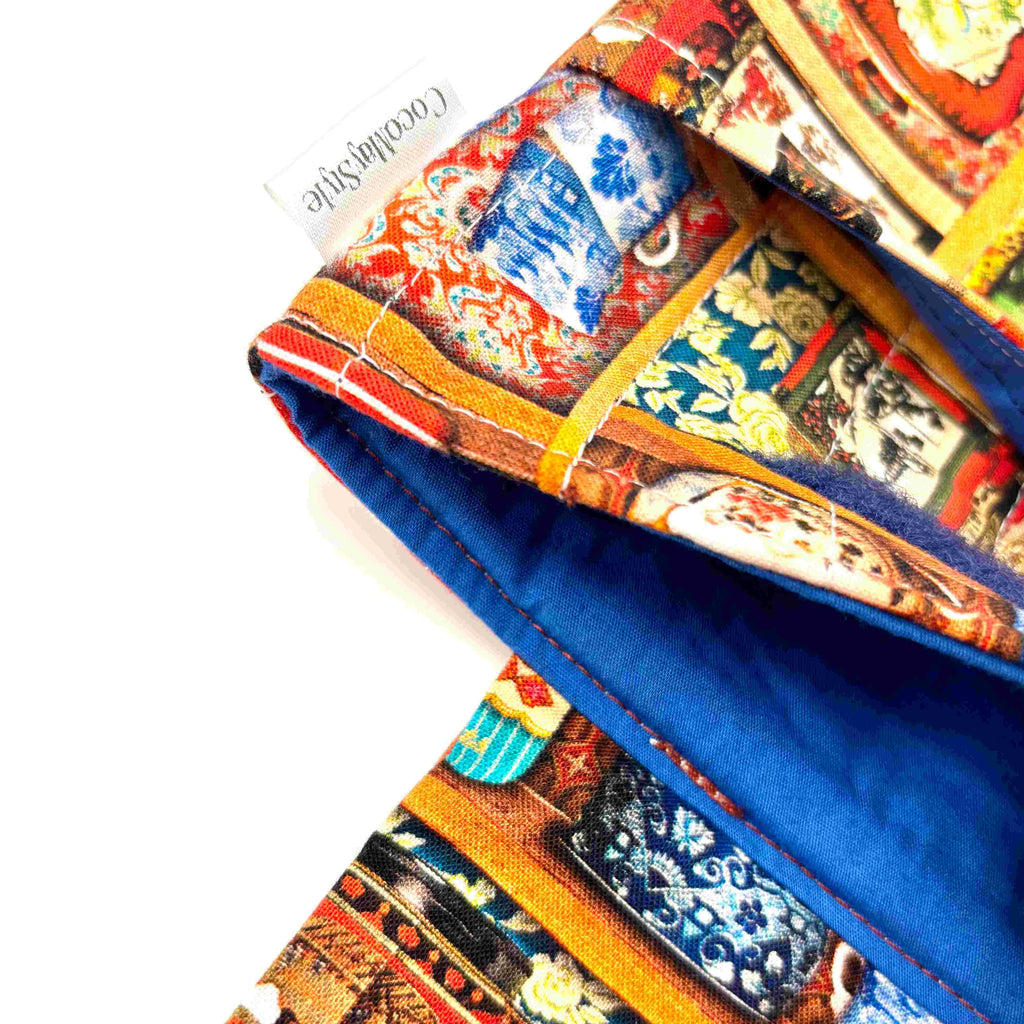 Close-up of e-Reader sleeve with colorful tea tins displayed on a shelf pattern