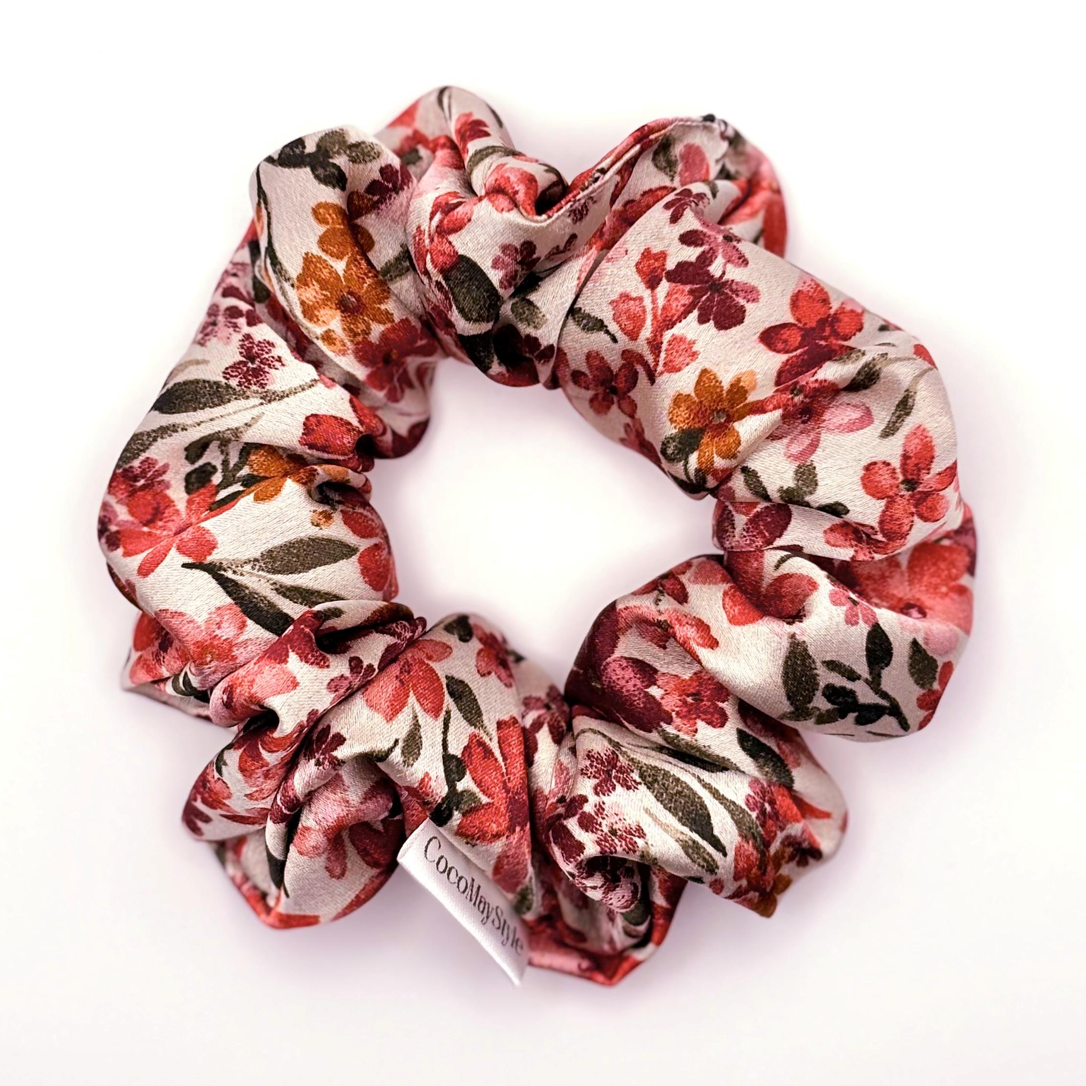 Floral patterned satin scrunchie on a white background