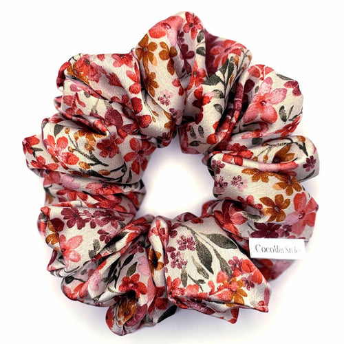 Floral patterned satin scrunchie on a white background