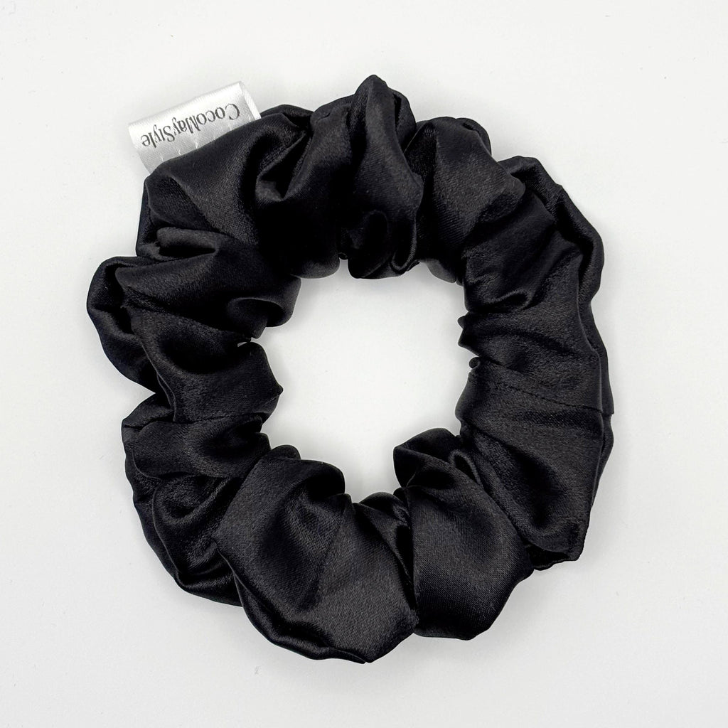 Black satin scrunchie on a white background