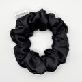 Black satin scrunchie on a white background