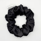 Black satin scrunchie on a white background
