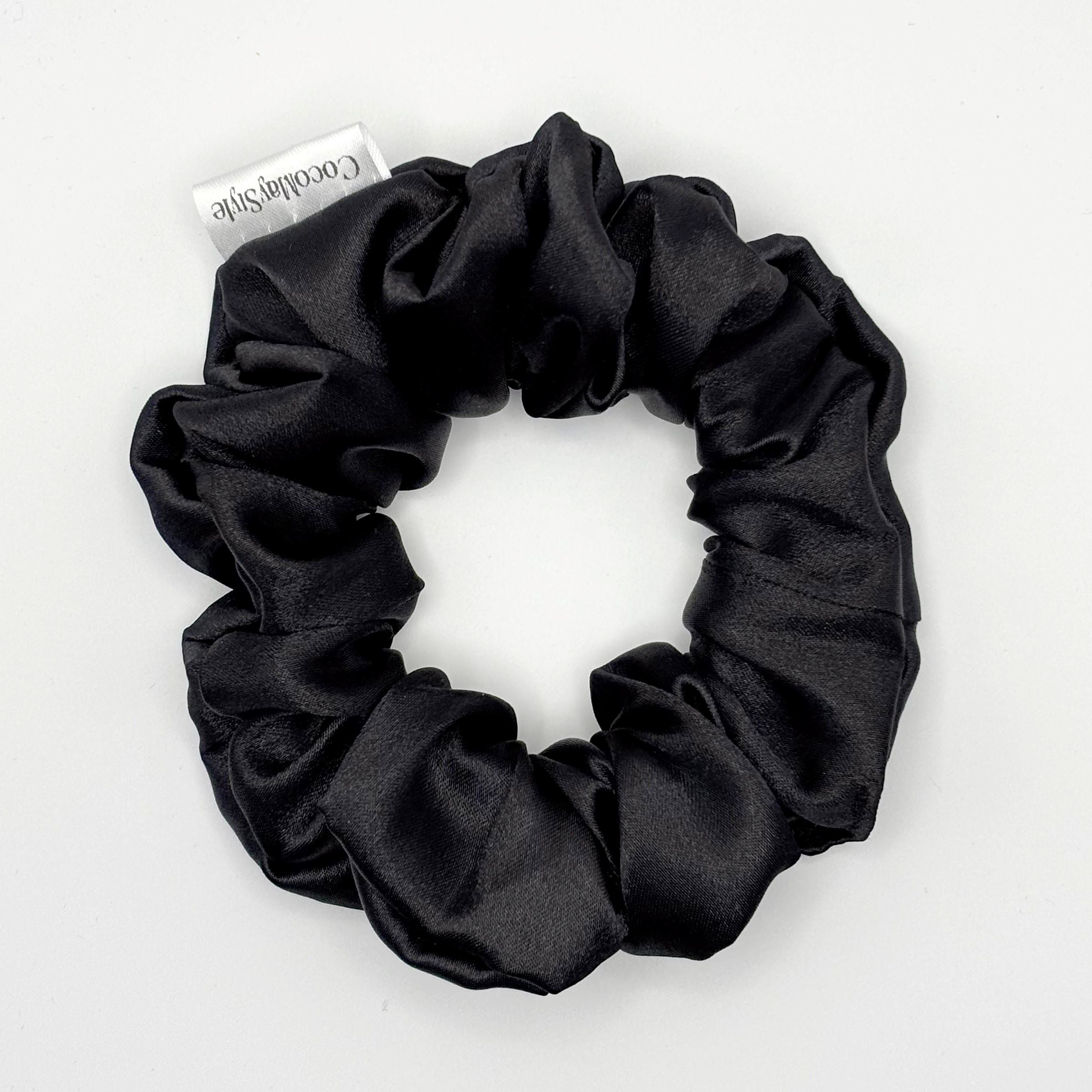 Black satin scrunchie on a white background