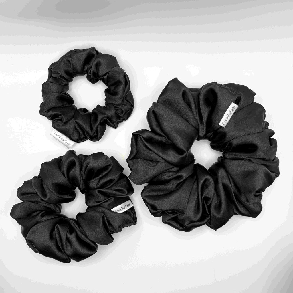 Black satin scrunchies on a white background
