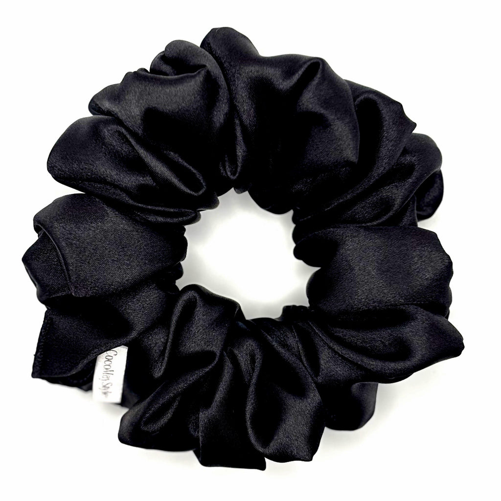 Black satin scrunchie on a white background