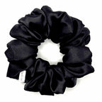 Black satin scrunchie on a white background
