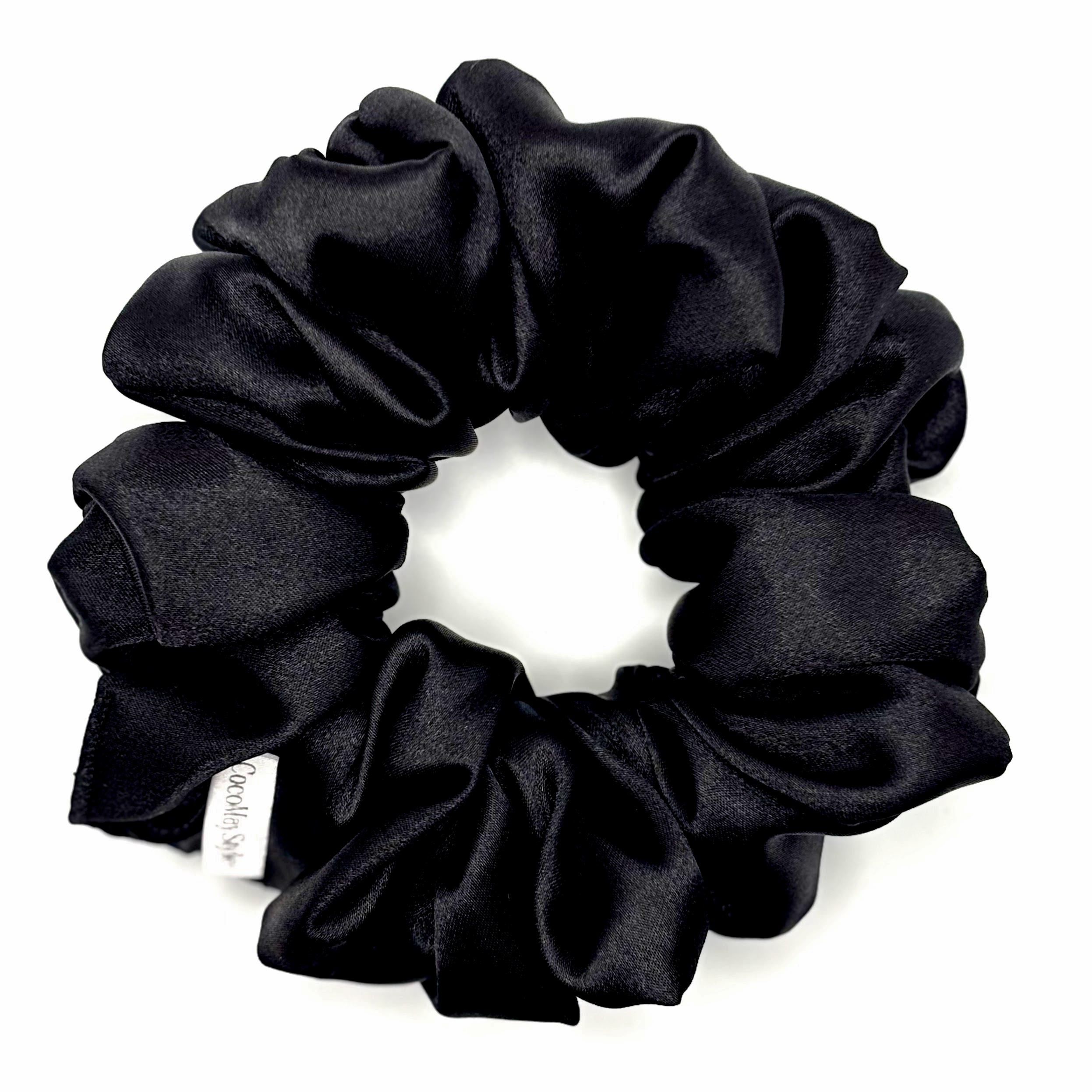 Black satin scrunchie on a white background