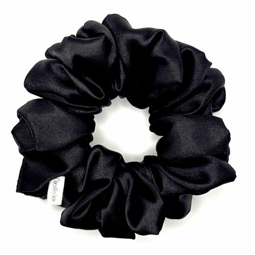 Black satin scrunchie on a white background