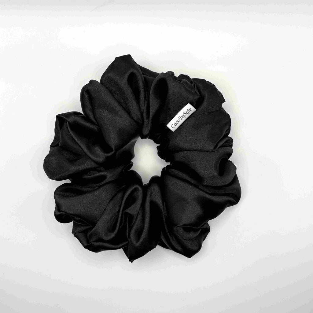 Black satin scrunchie on a white background