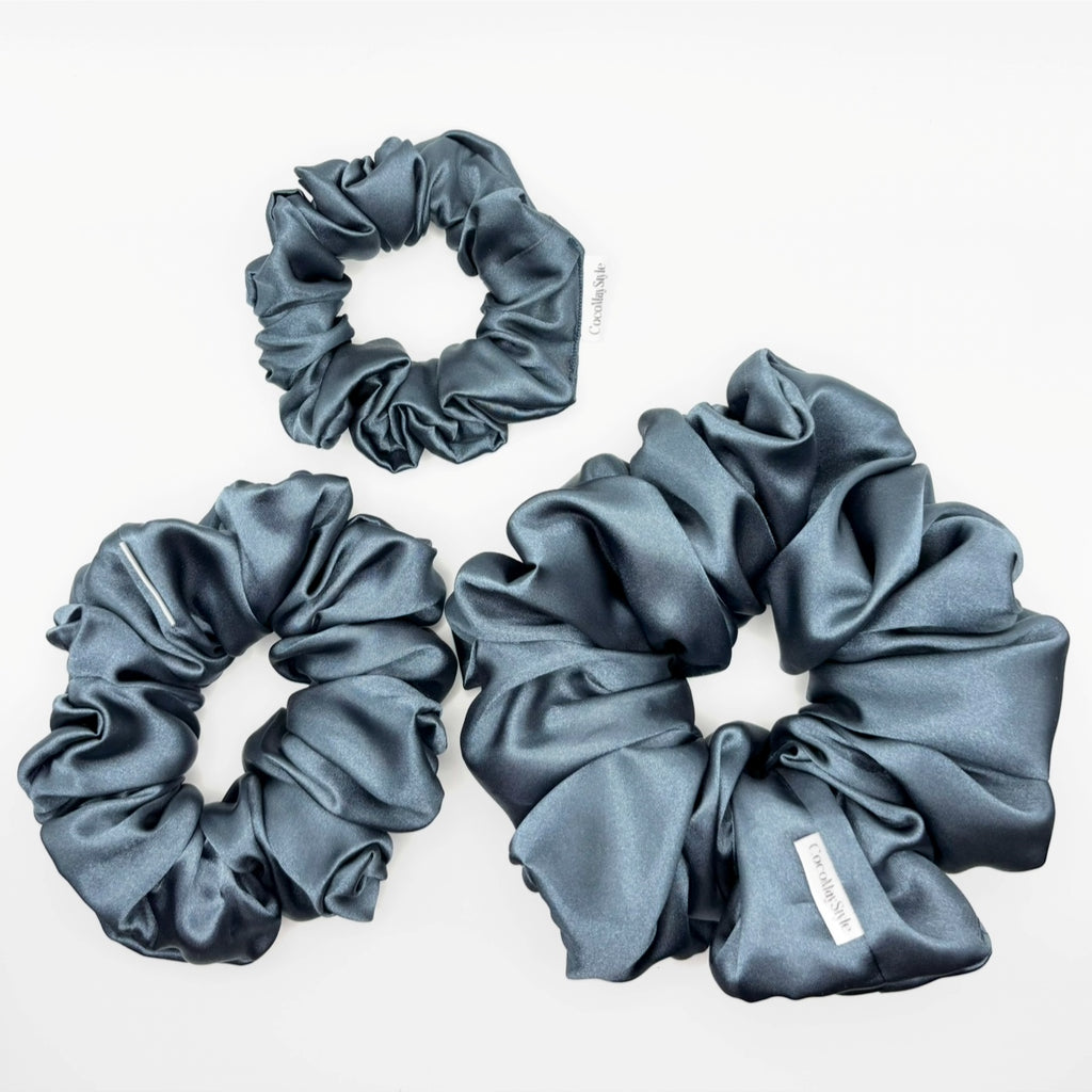Blue satin scrunchies on a white background