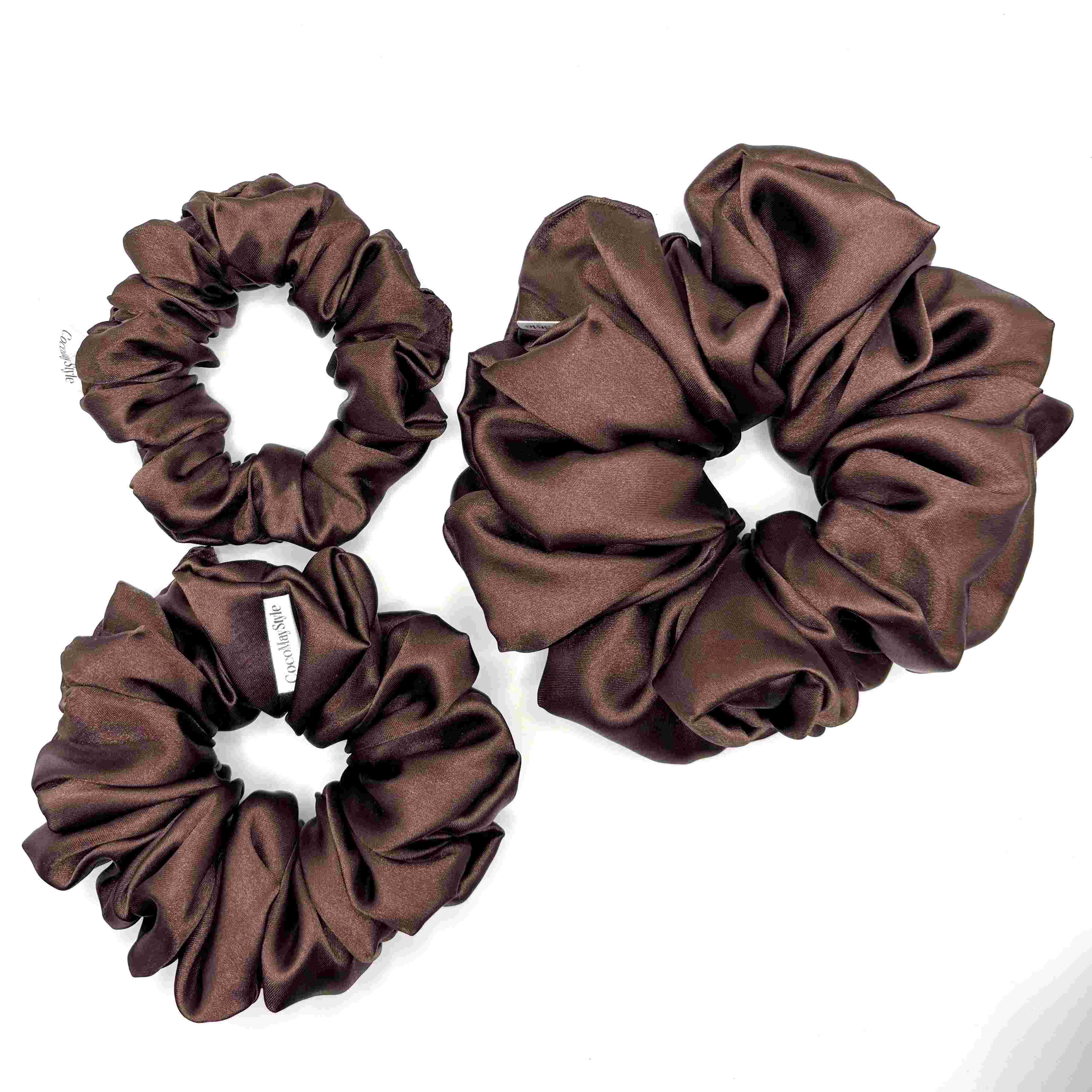 Dark brown satin scrunchies on a white background