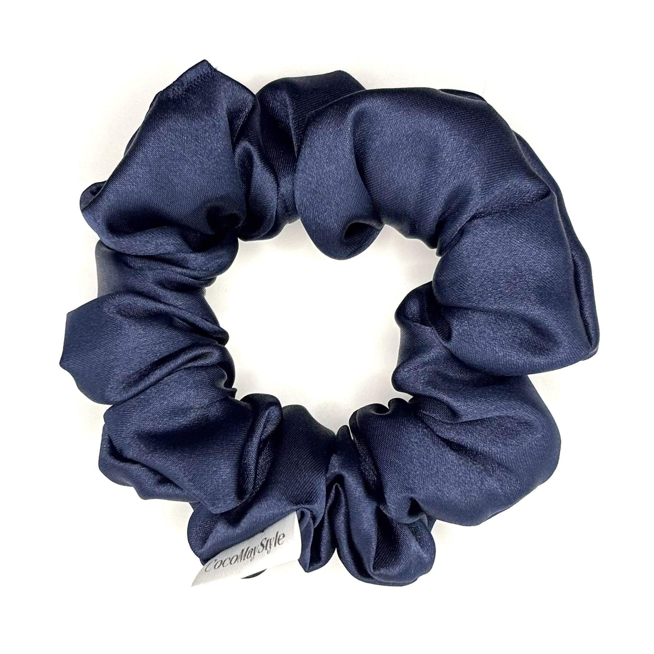 Dark blue satin scrunchie on a white background