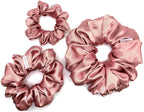 Pink satin scrunchies on a white background