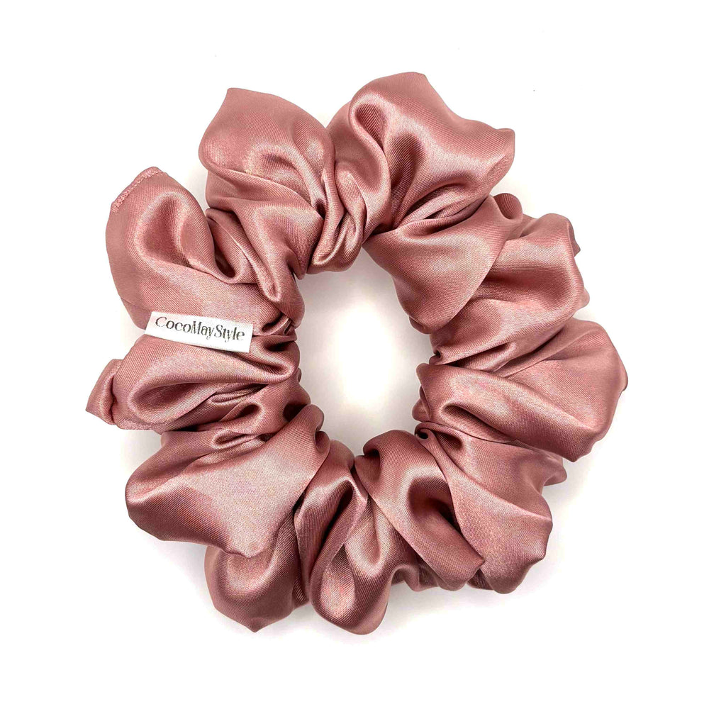 Pink satin scrunchie on a white background