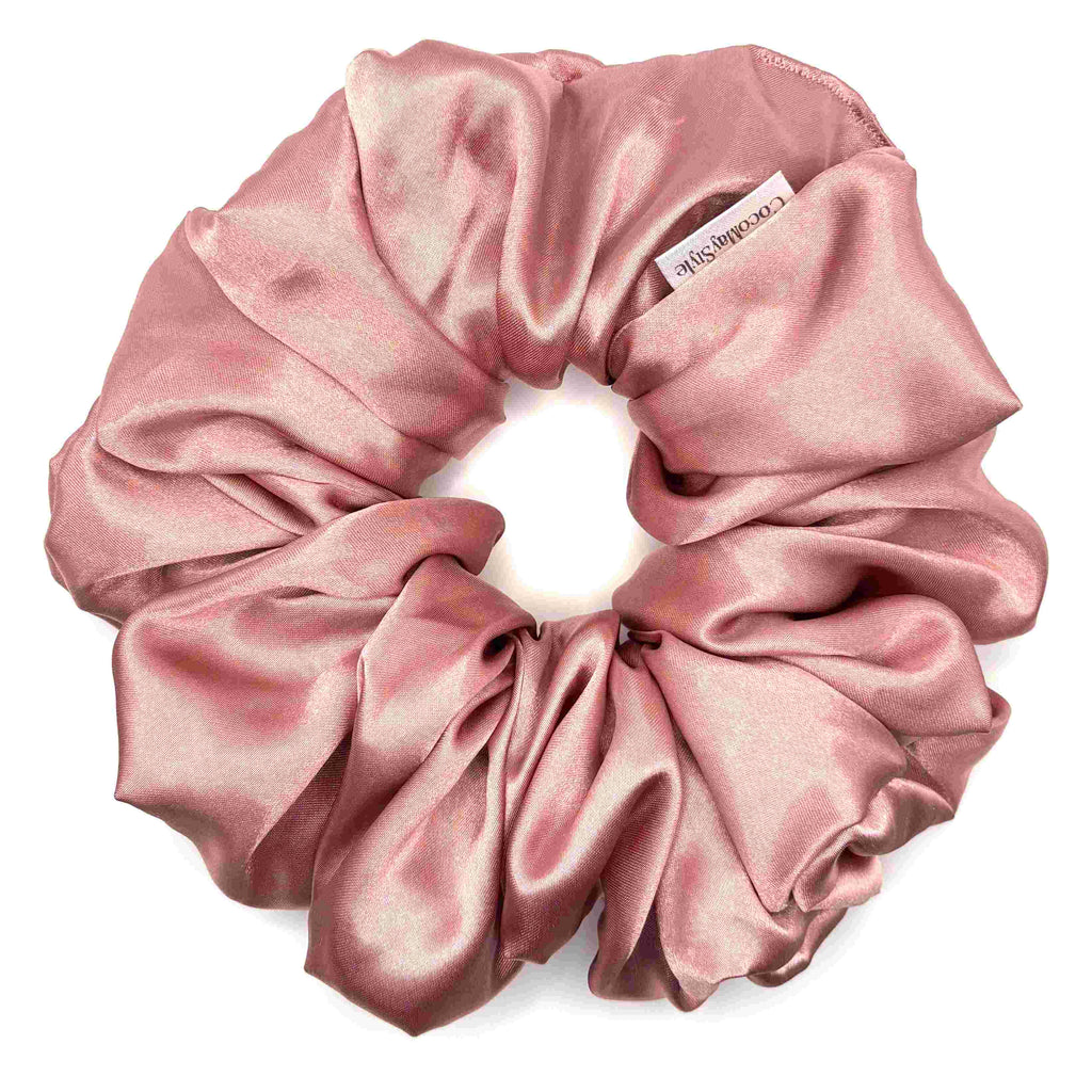 Pink satin scrunchie on a white background