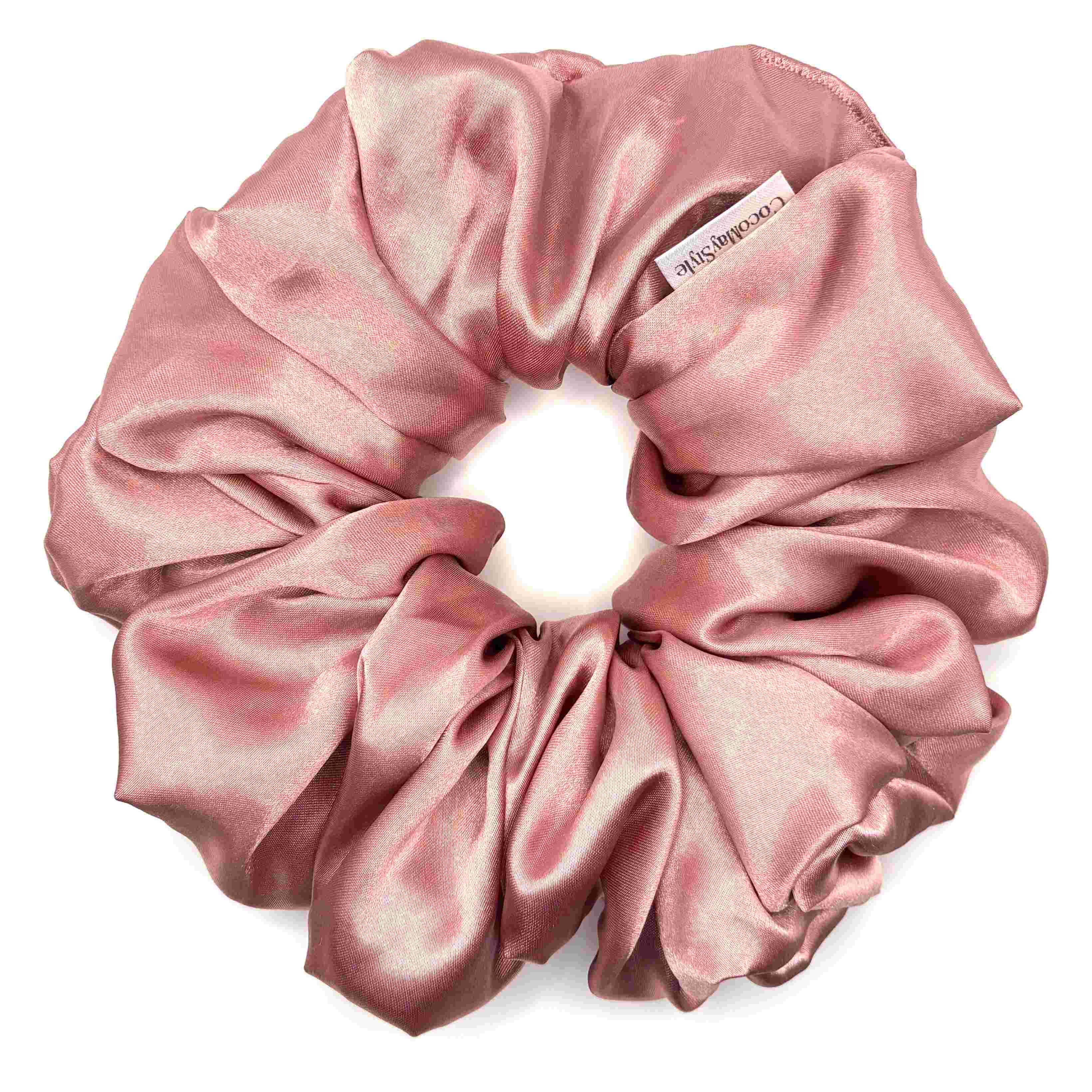Pink satin scrunchie on a white background
