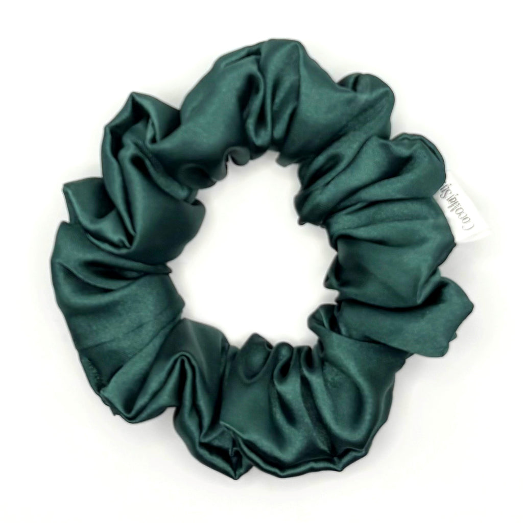 Dark green satin scrunchie on a white background