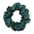 Dark green satin scrunchie on a white background