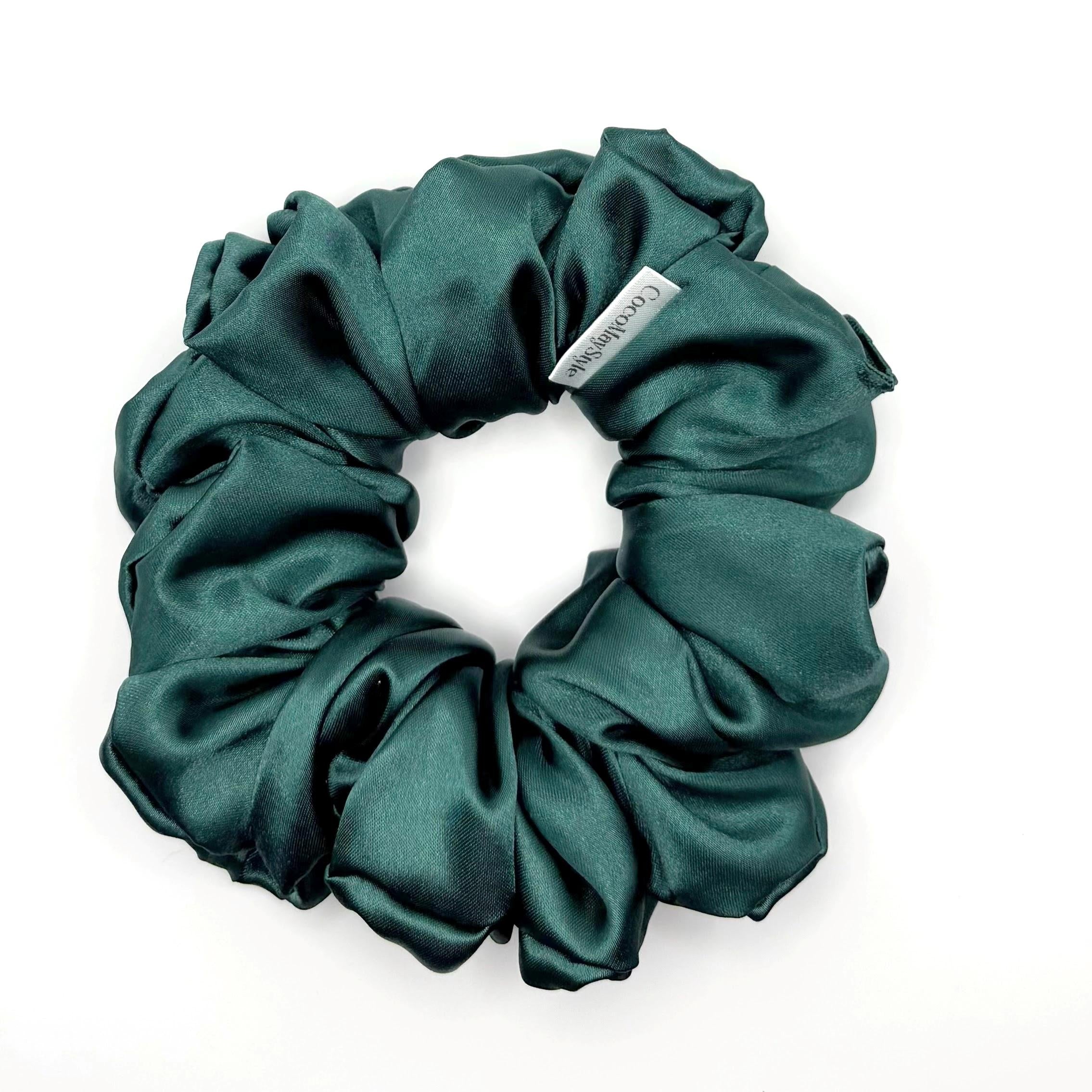 Dark green satin scrunchie on a white background