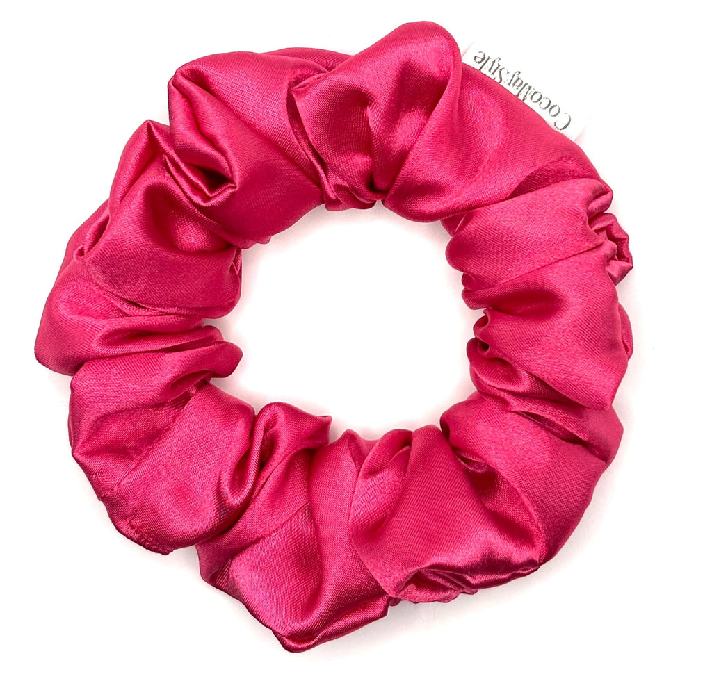 Hot pink satin scrunchie on a white background