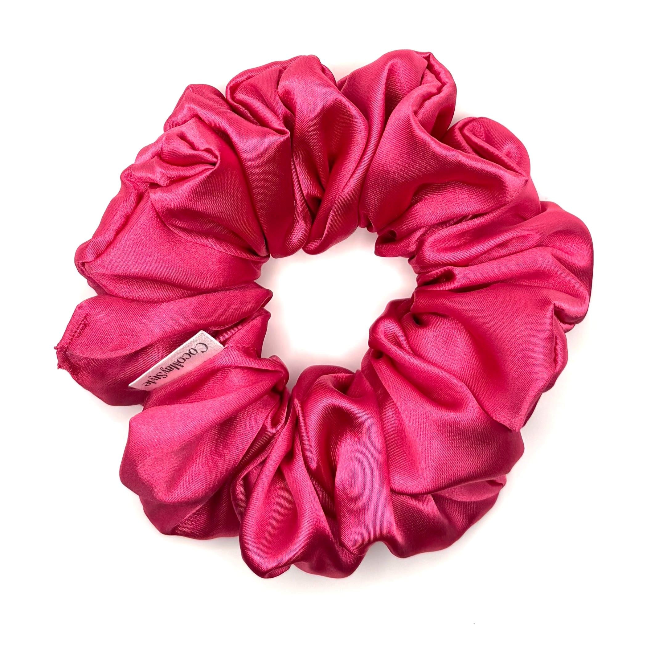 Hot pink satin scrunchie on a white background