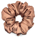 Light brown/tan satin scrunchie on a white background
