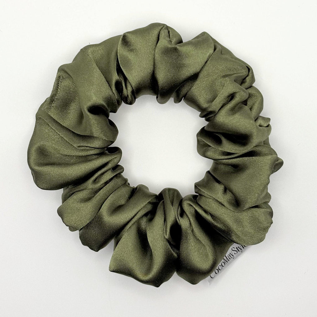 Olive green satin scrunchie on a white background