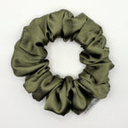 Olive green satin scrunchie on a white background