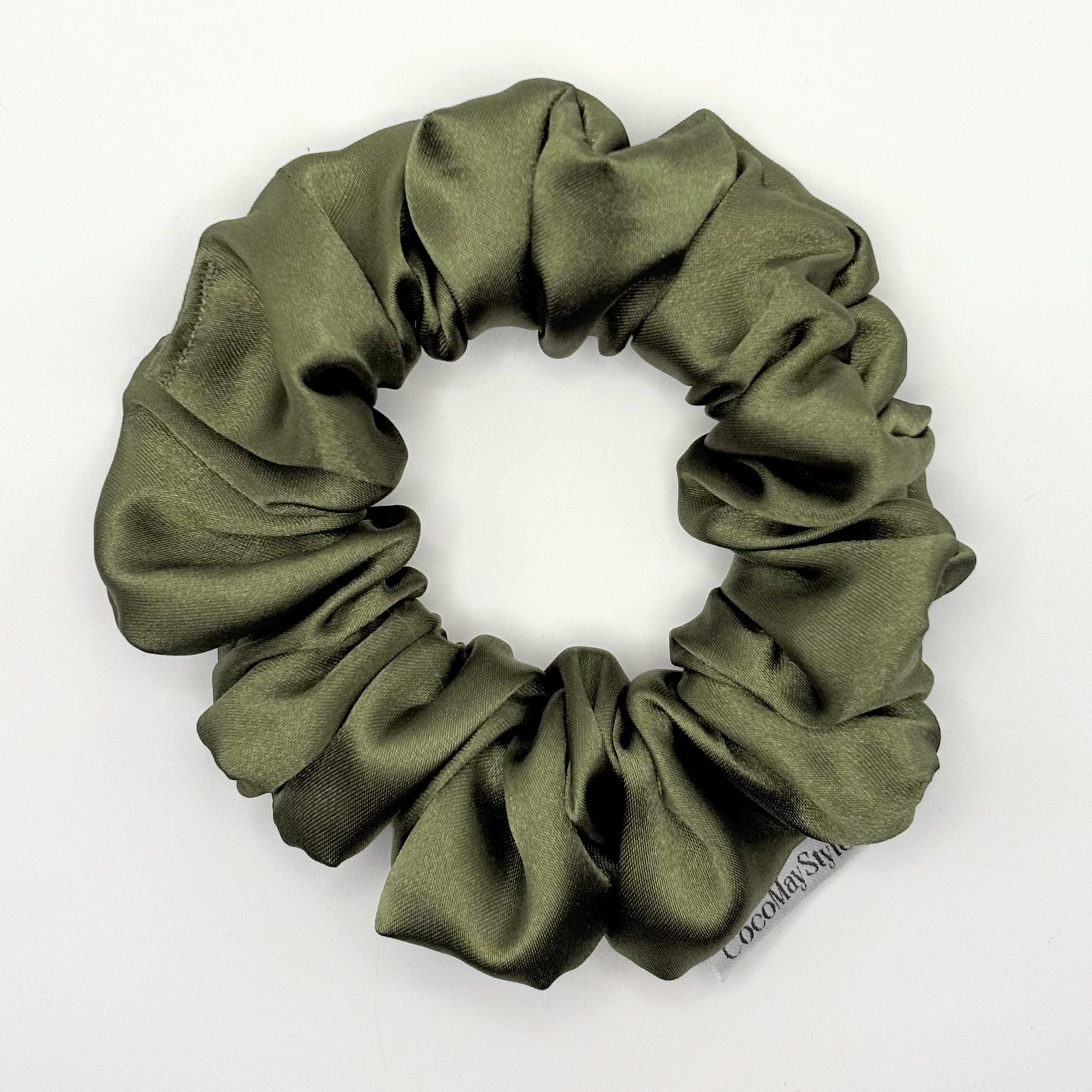 Olive green satin scrunchie on a white background