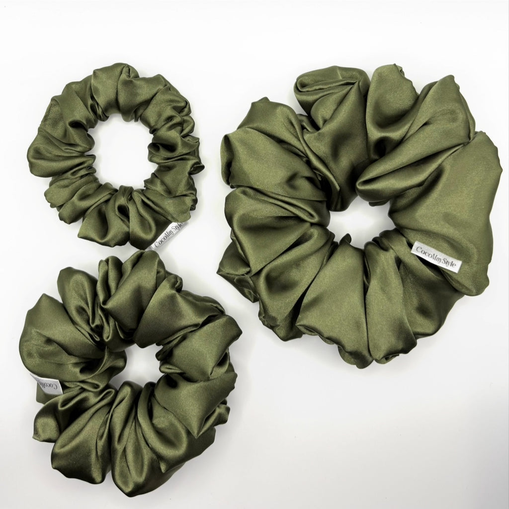 Olive green satin scrunchies on a white background