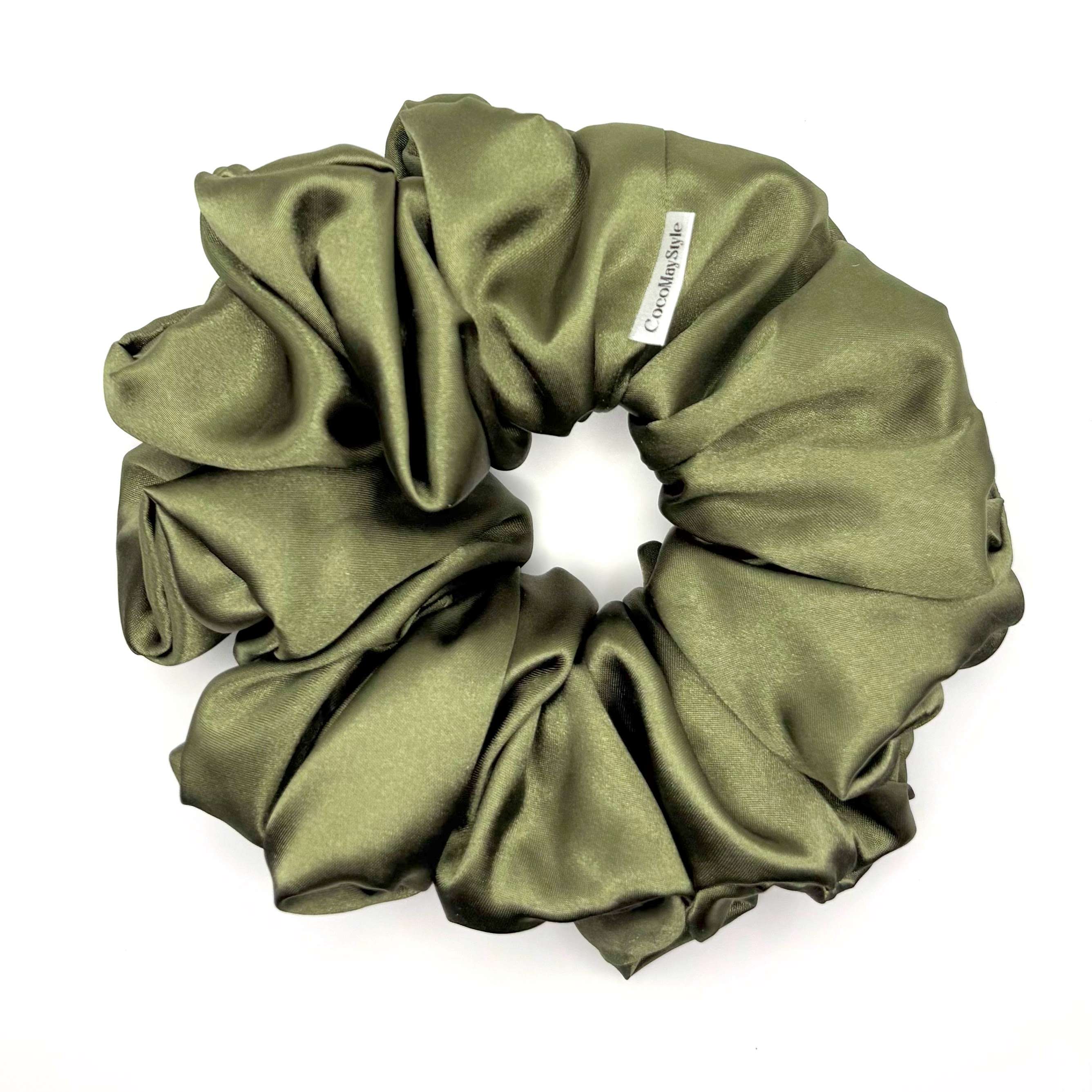 Olive green satin scrunchie on a white background