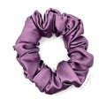 Purple satin scrunchie on a white background